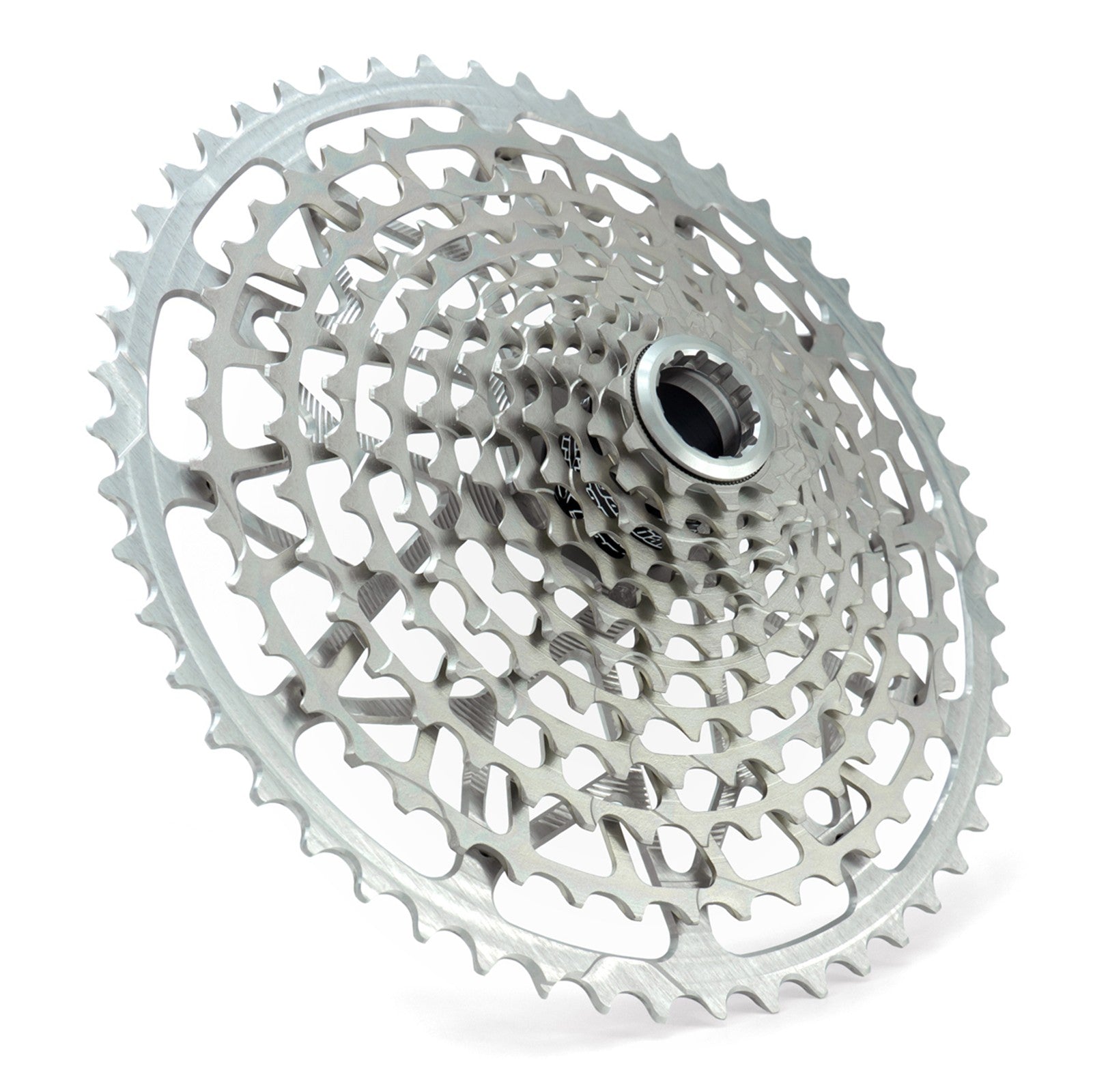 Angled view of a Garbaruk 12sp Shimano Microspline cassette in silver, highlighting the CNC-machined monoblock construction and unique tooth profiling