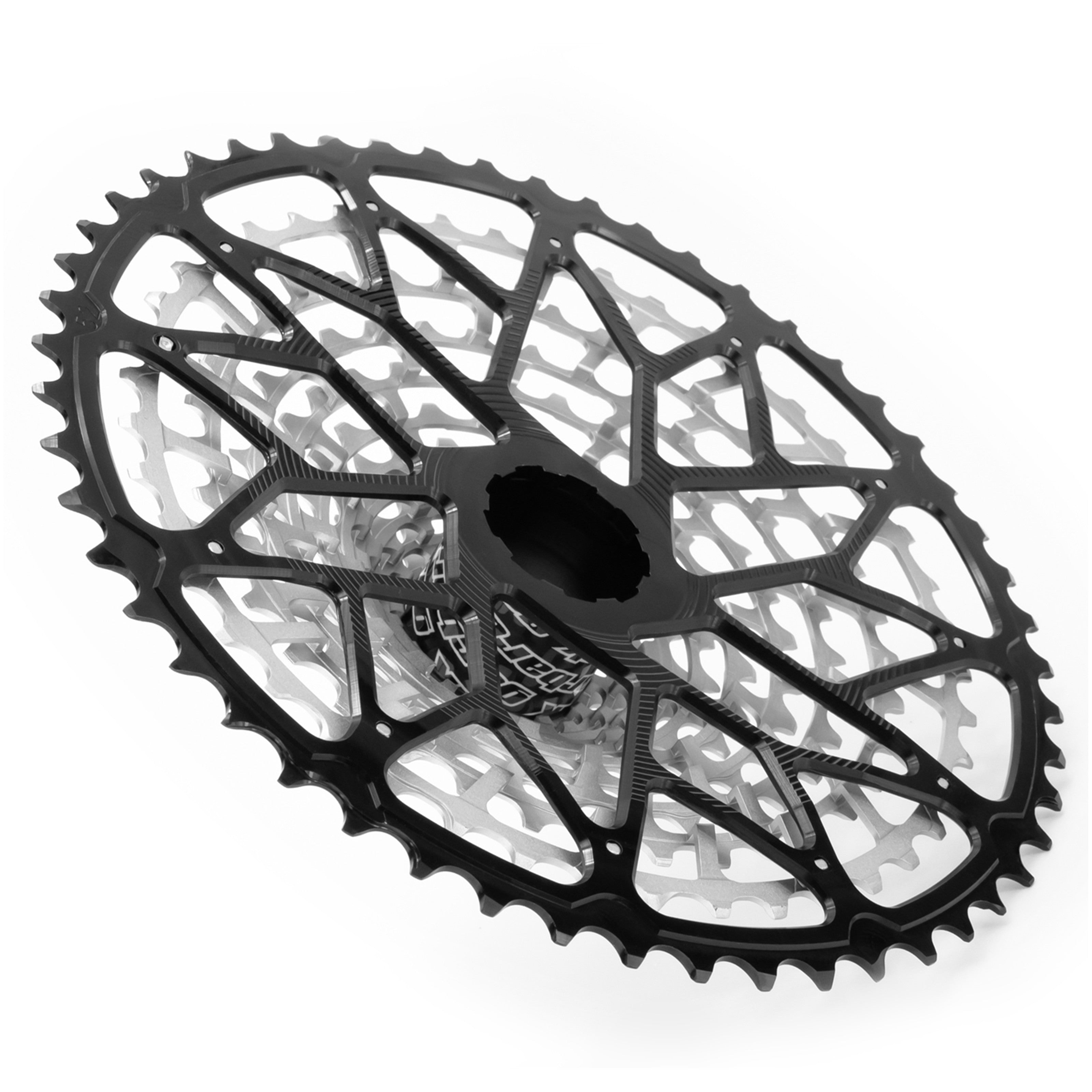 Angled rear view of the Garbaruk 12sp cassette Shimano in black, highlighting the largest aluminium cog, CNC-machined monoblock construction and unique tooth profiling