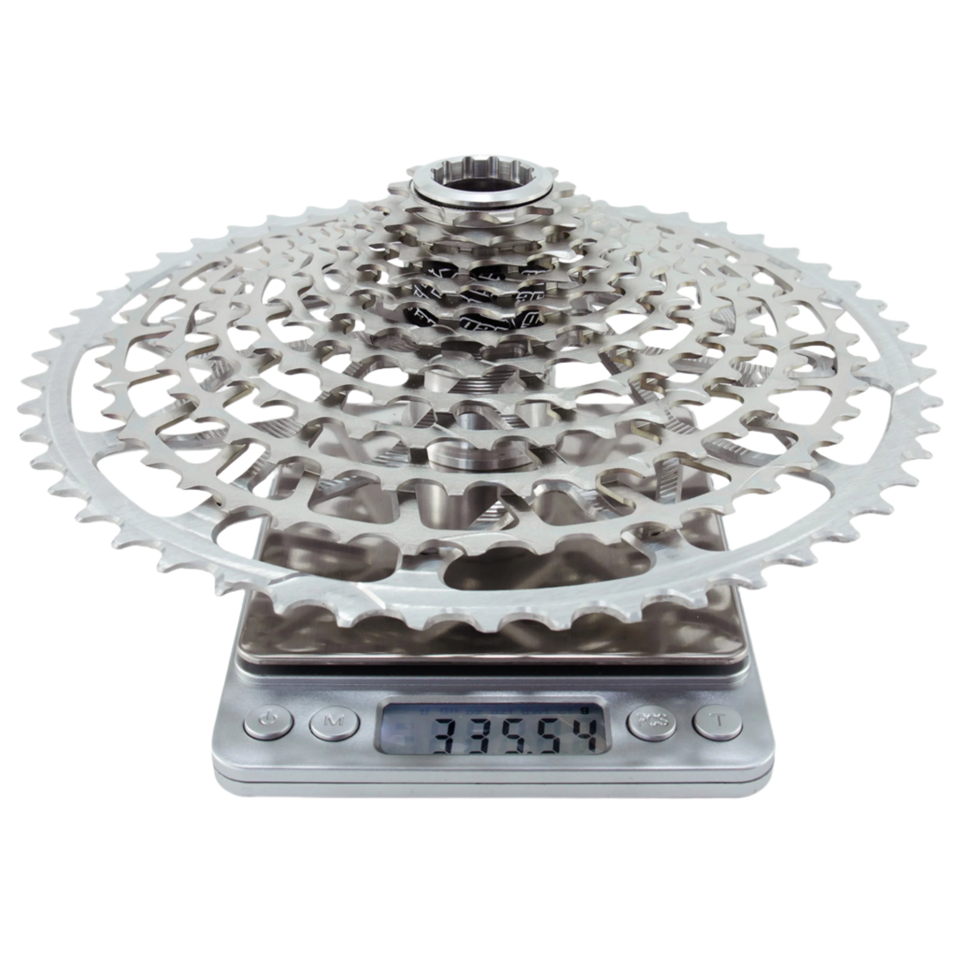 Silver Garbaruk 12sp Shimano Microspline cassette on a digital scale; the display reads 335.54g.
