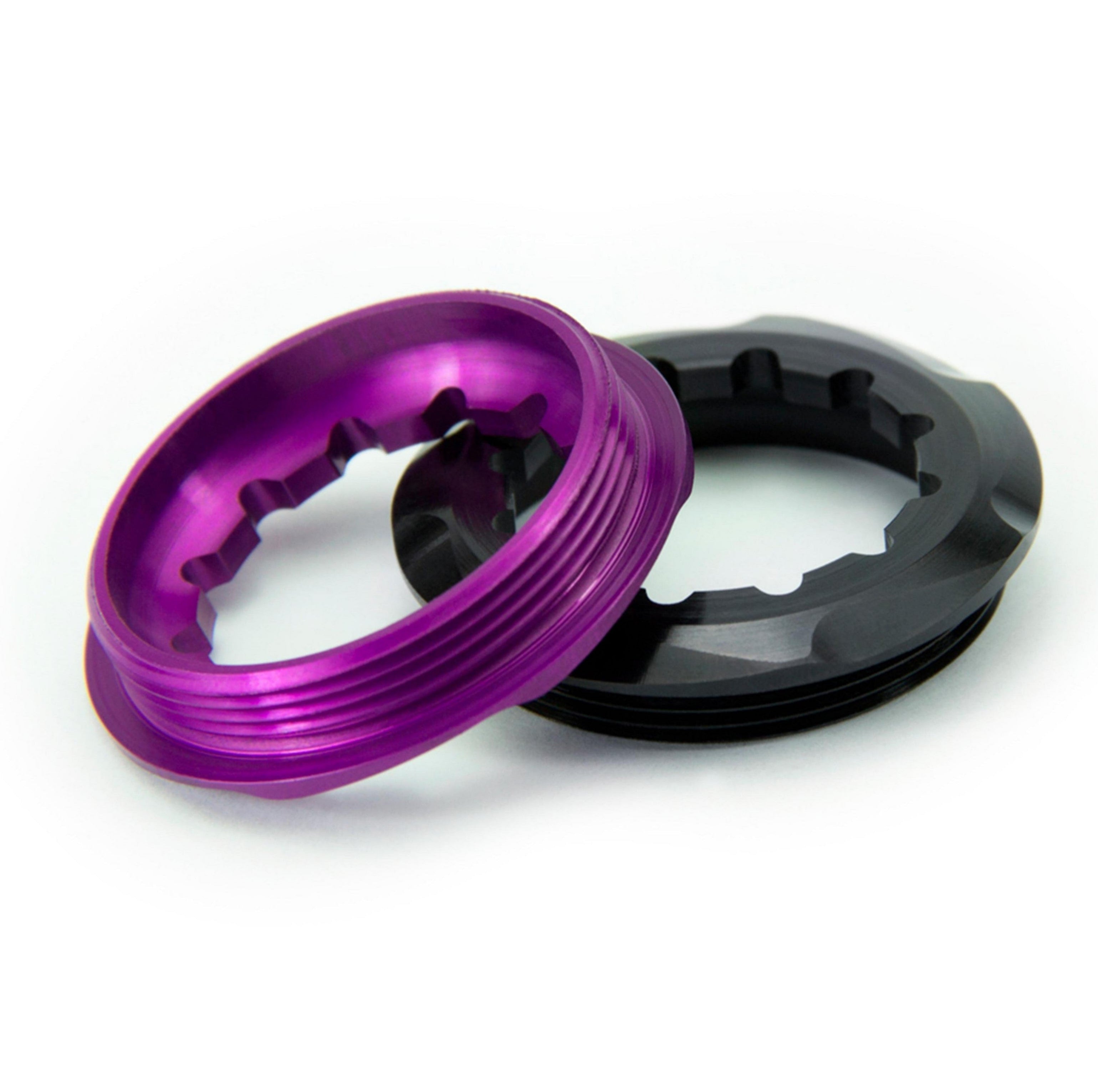 Side view of Garbaruk lockrings in purple and black, showing detailed machining and minimalist design