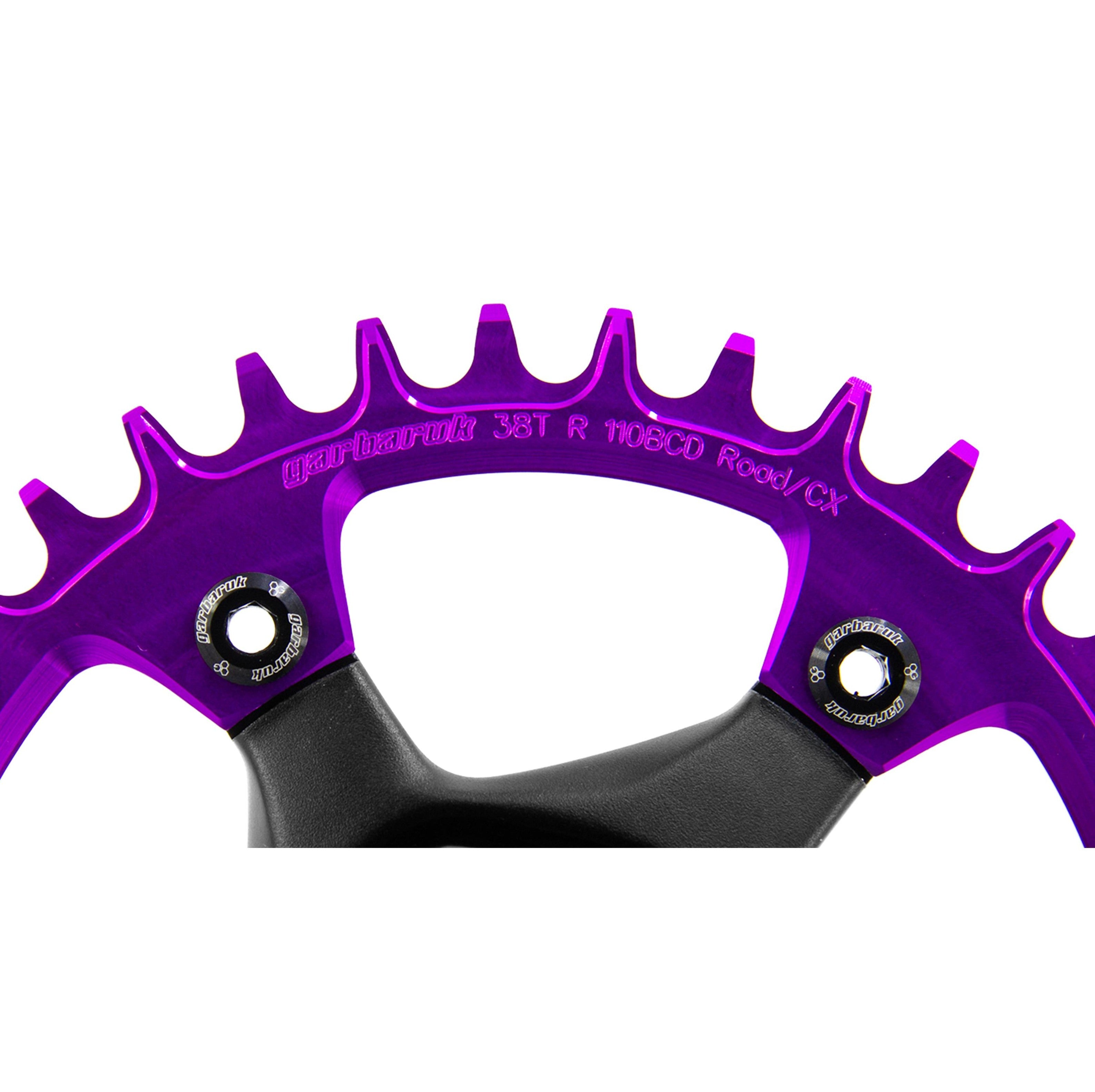 Close-up view of black Garbaruk chainring bolts installed on a violet Garbaruk chainring, highlighting colour contrast and secure fit