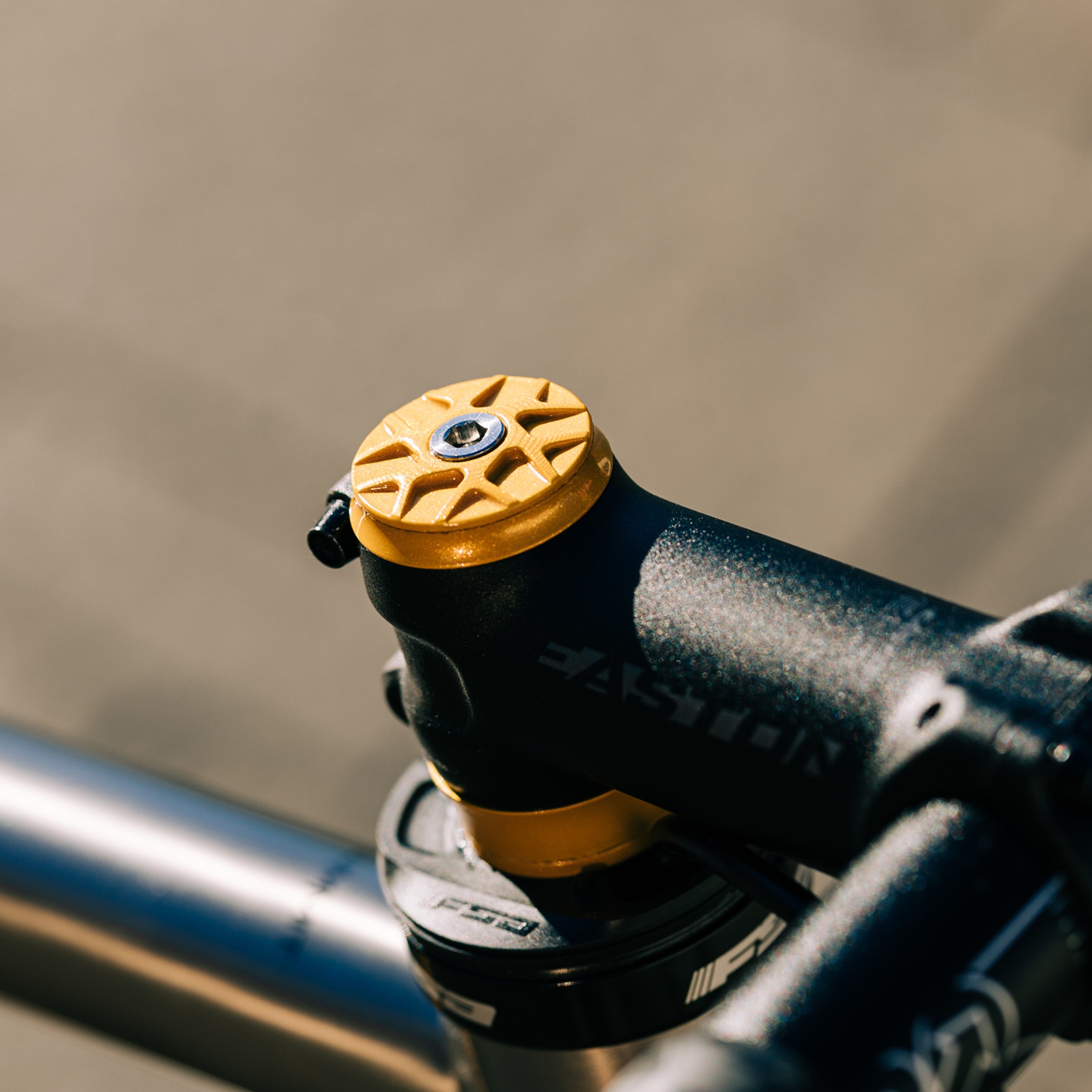 Gold Garbaruk top cap installed on a titanium Bossi bike, blending sleek aesthetics with functional performance