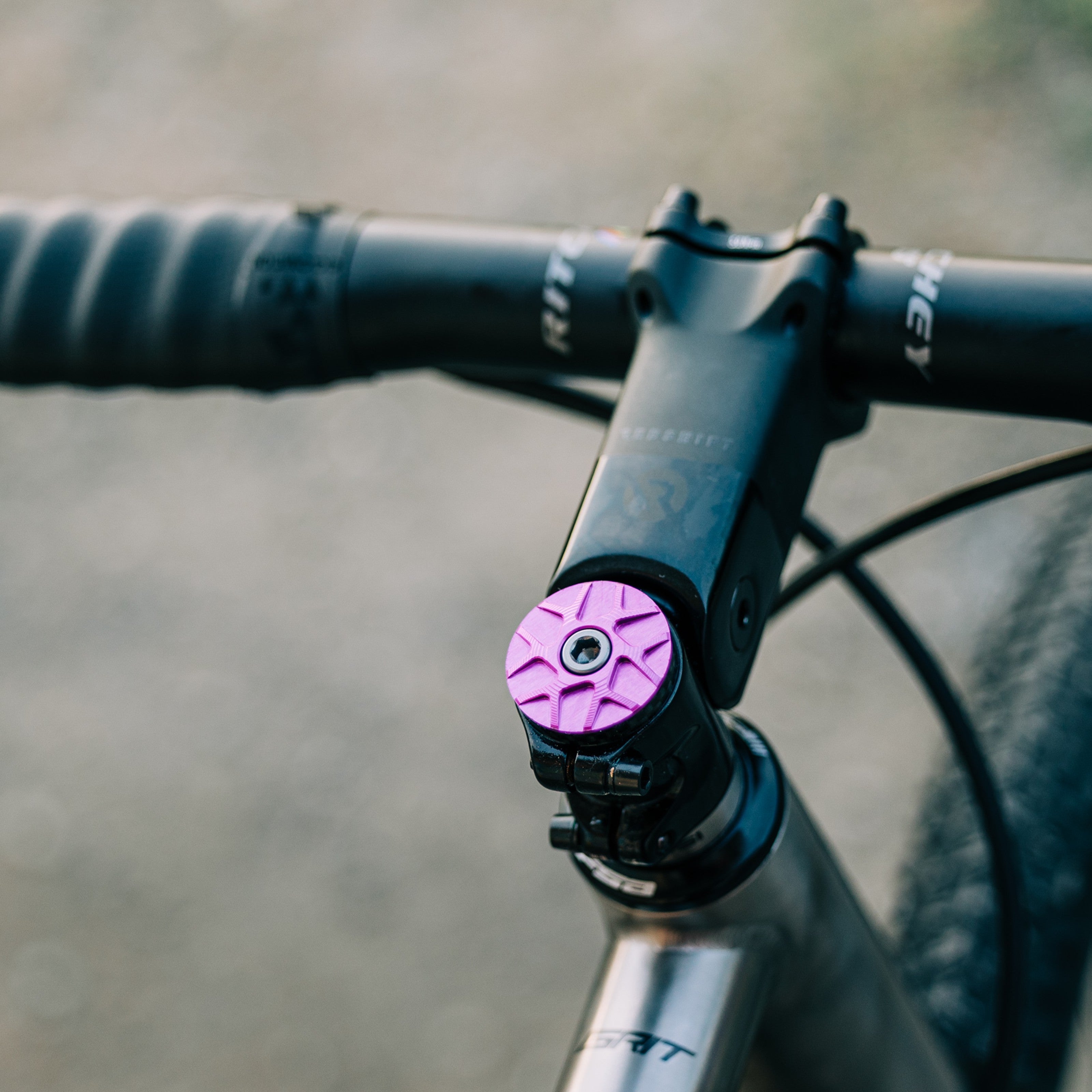Garbaruk stem cap in violet installed on a titanium Bossi bike, showing seamless integration with premium componentse
