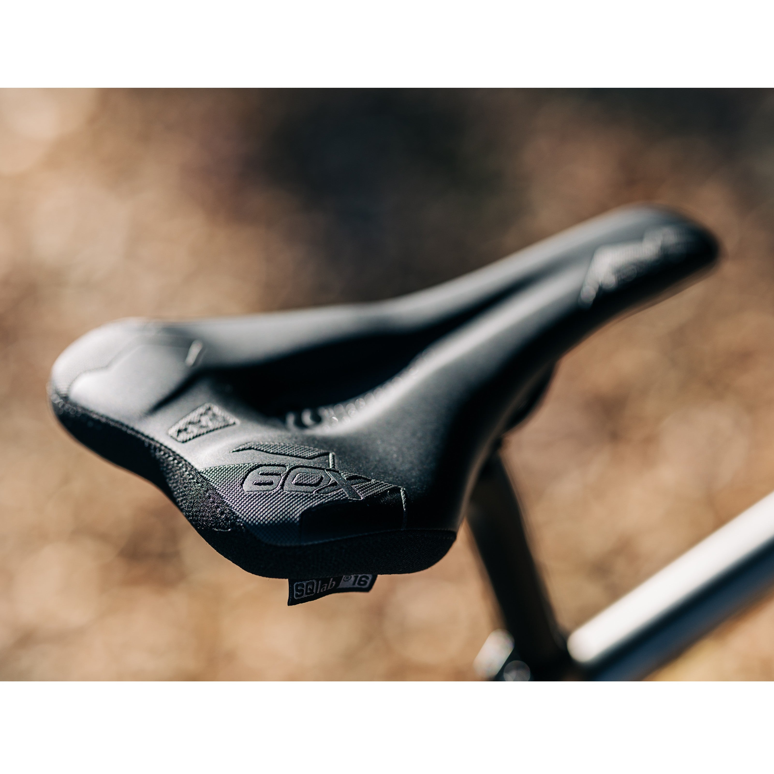 SQLab 60X saddle installed on a trail bike, showcasing aggressive support and tuned flexibility