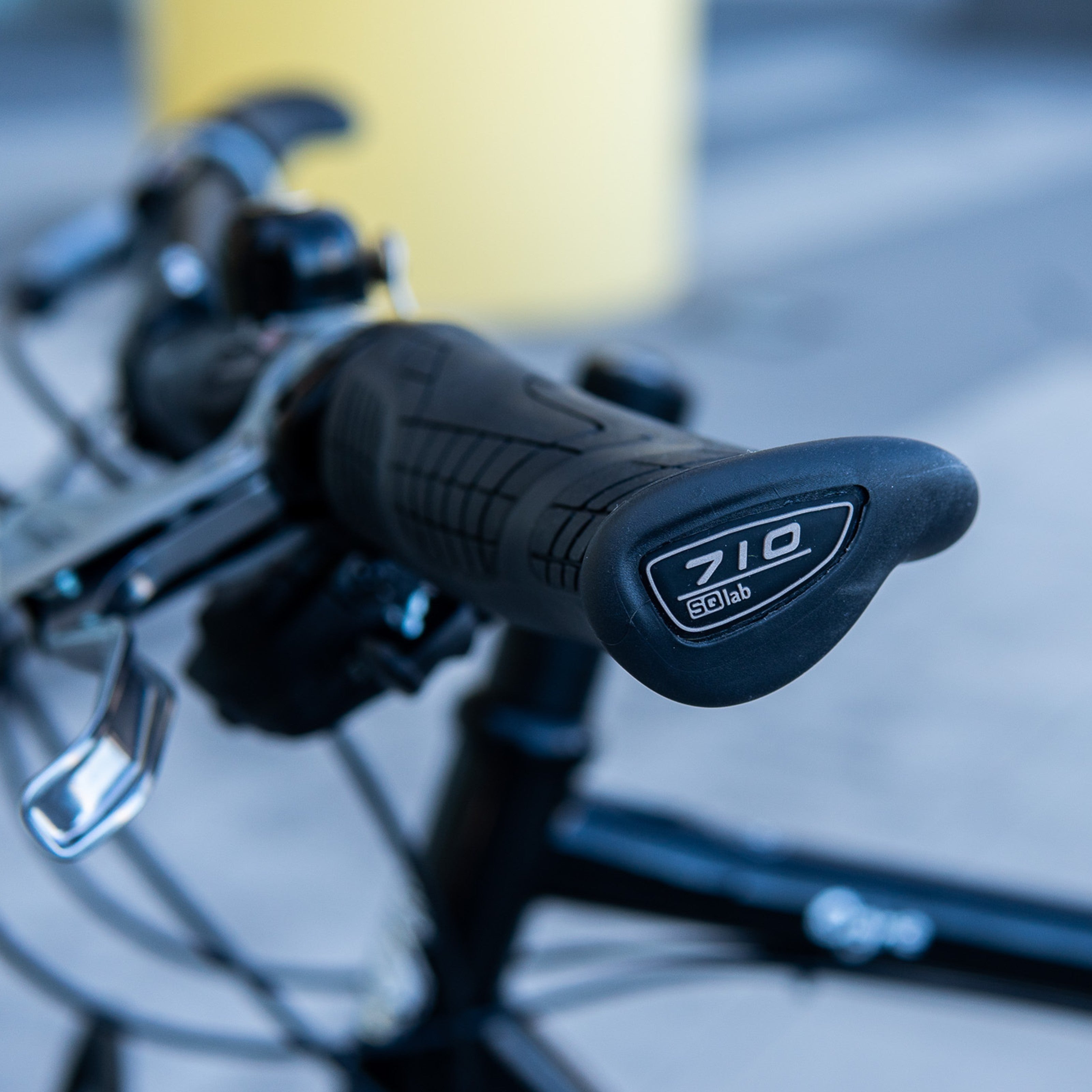 Close-up of SQLab 710 grips mounted to flat handlebars pn a Surly Ogre, showing ergonomic shape in real-world setup