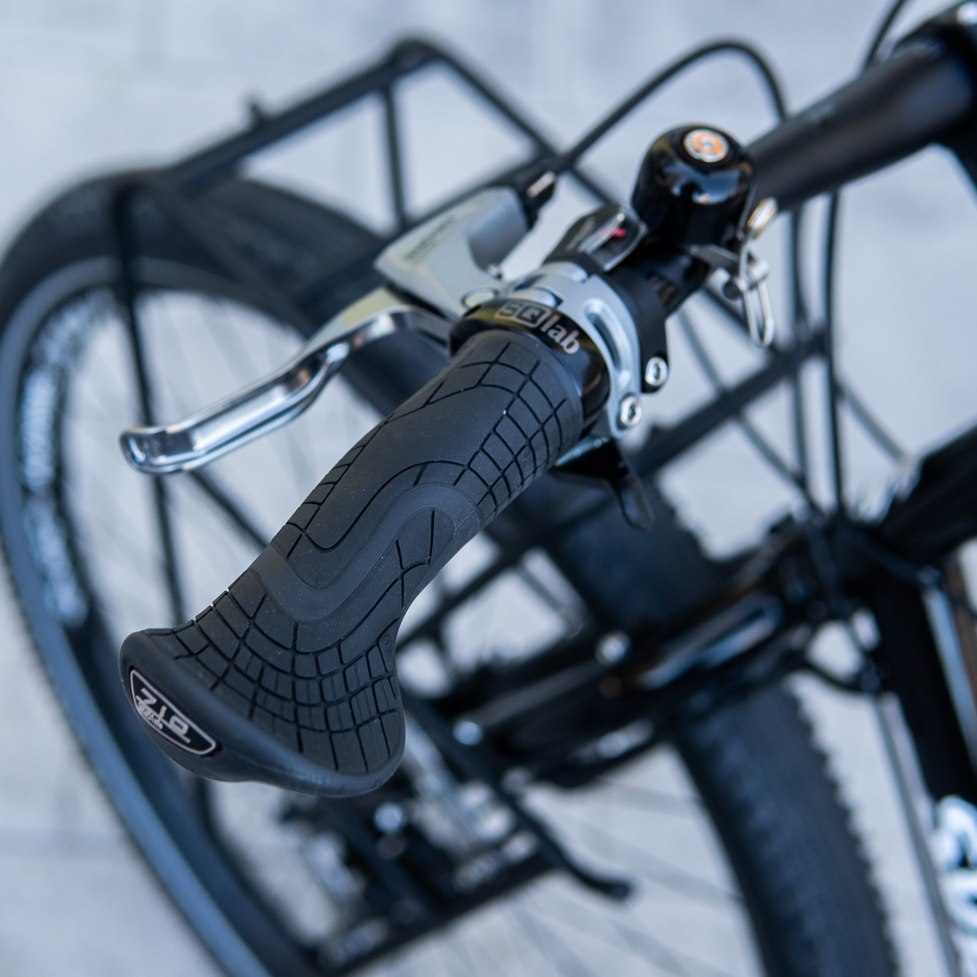 SQLab 710 grips installed on a custom-built Surly Ogre, photographed outdoors against a concrete floor