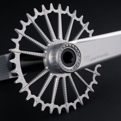 Garbaruk DM MTB chainring in silver, designed for mountain bike cranksets, showing precise CNC machining, mounted to a silver Garbaruk crankset