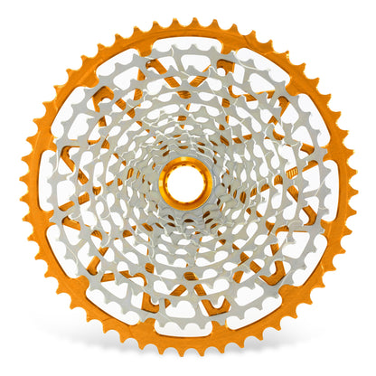 Garbaruk 12sp Shimano Microspline cassette in orange, highlighting the CNC-machined monoblock construction and unique tooth profiling