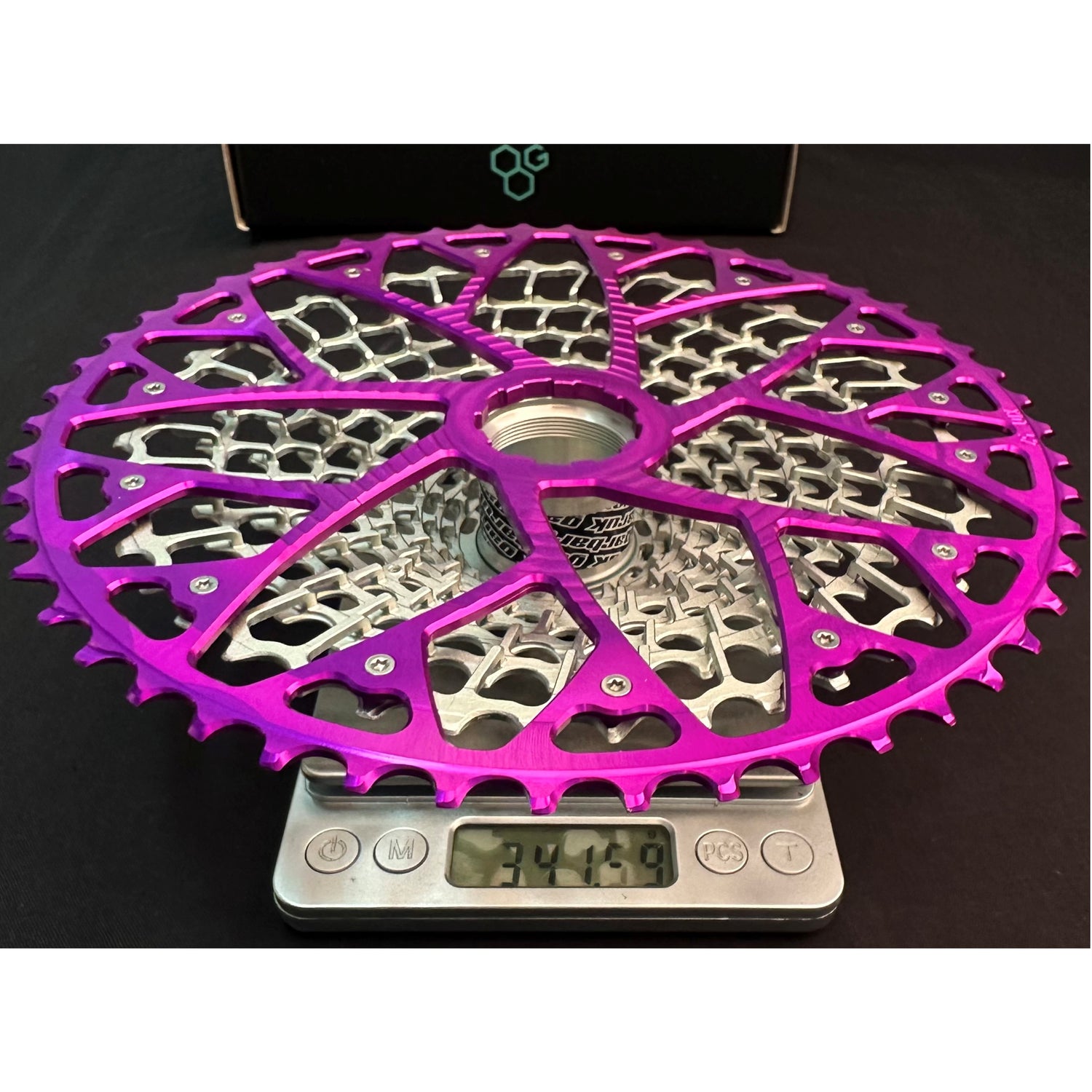 Garbaruk 12sp GEN2.0 MTB cassette for SRAM Eagle Transmission on a scale showing its weight of 341.59g.