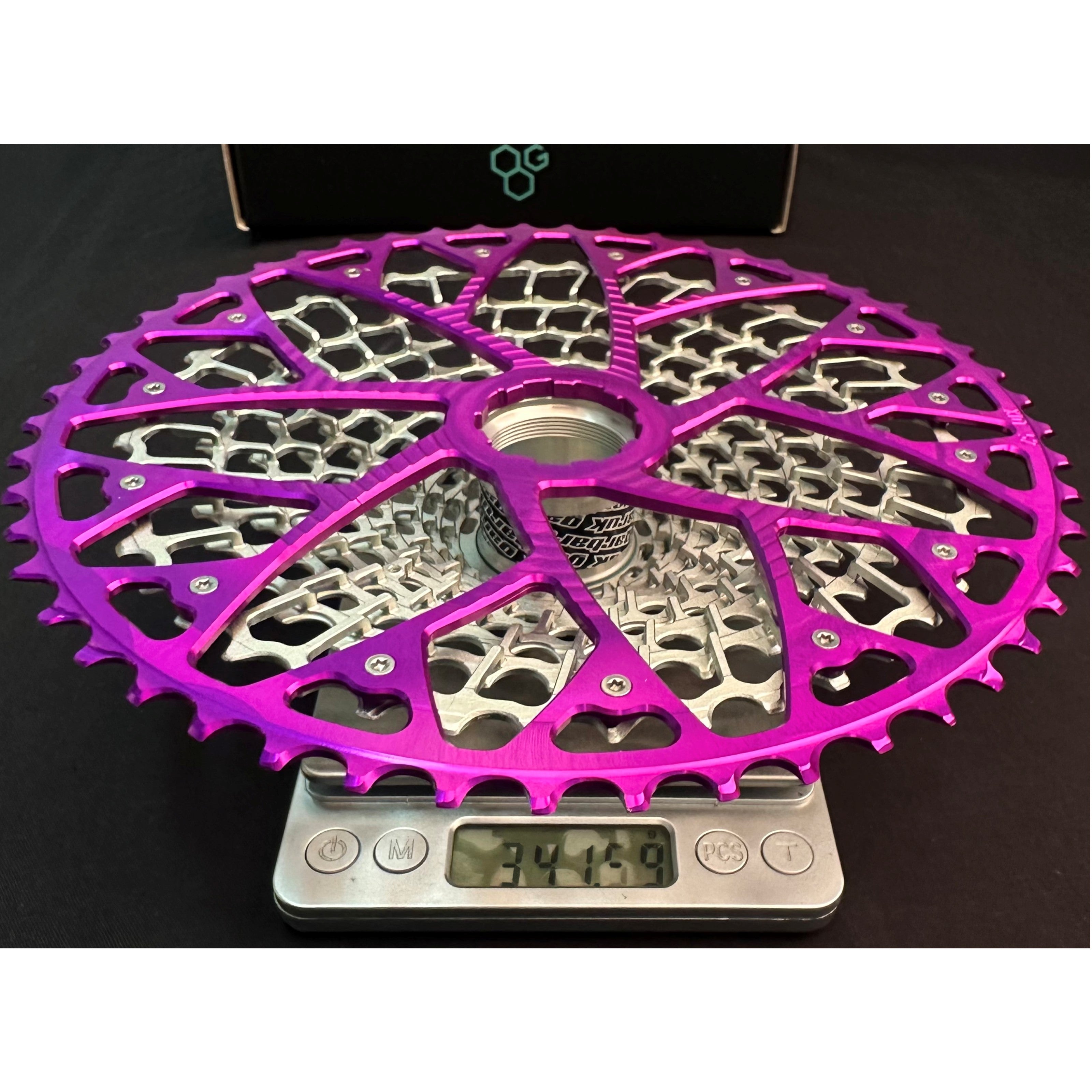 Garbaruk 12sp GEN2.0 MTB cassette for SRAM Eagle Transmission on a scale showing its weight of 341.59g.