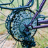 Garbaruk 12sp Shimano Microspline cassette in black, fitted to a purple custom-built Surly Karate Monkey, shot outdoors against a grassy background