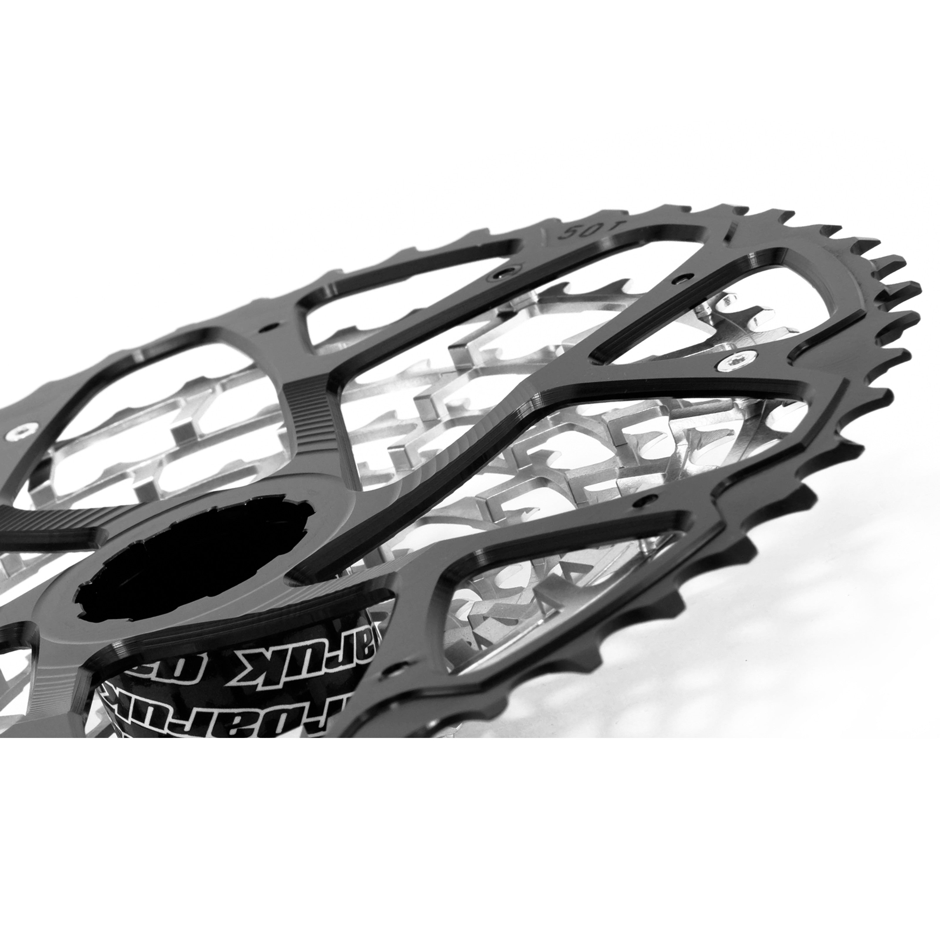 Angled rear view of a Garbaruk Shimano 11sp cassette, highlighting the largest anodised cog and precision engineering