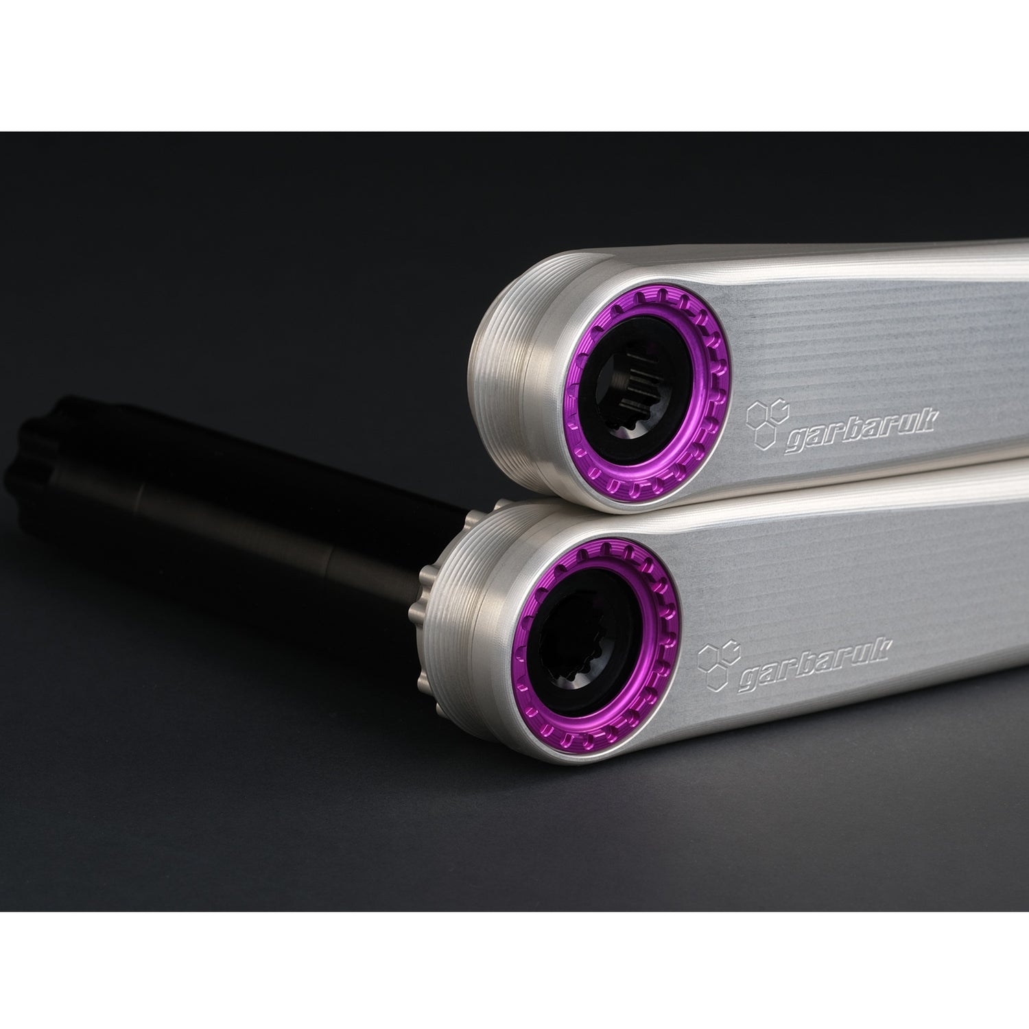 Detail of Garbaruk XC silver crank arms with violet extractors, highlighting CNC-machined precision and machining quality