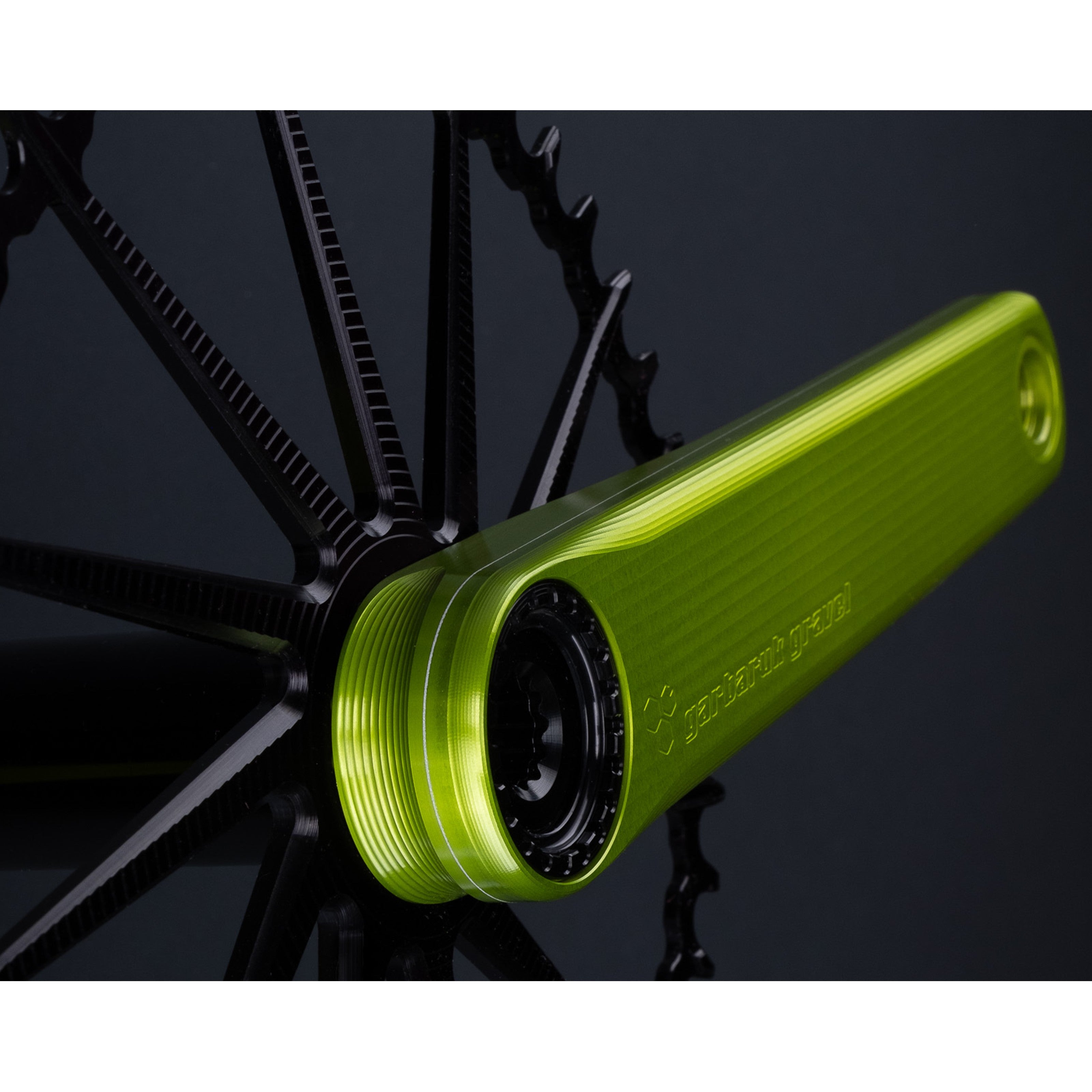 Detail of crank arm texture and construction on a green Garbaruk road/gravel crankset, a black Garbaruk chainring installed