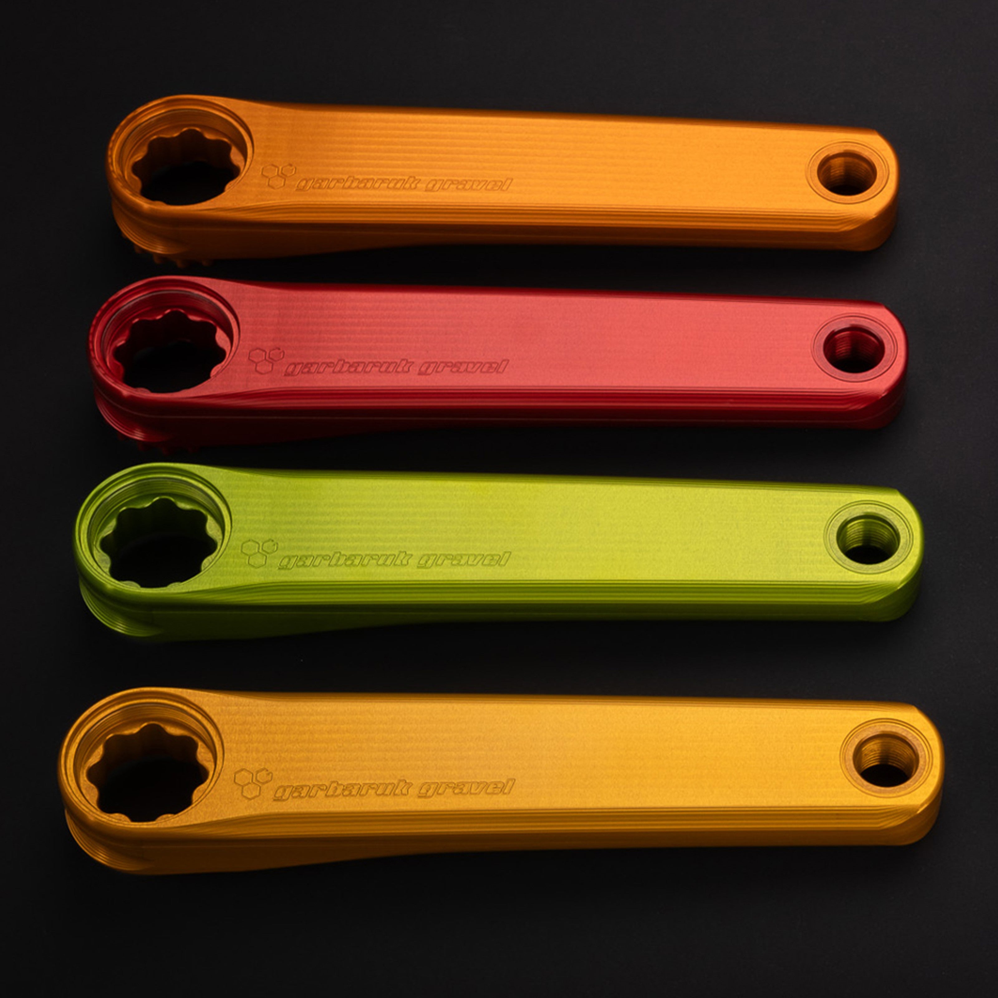 Garbaruk crank arms shown in different colours, highlighting anodised finish and lightweight, performance-driven design