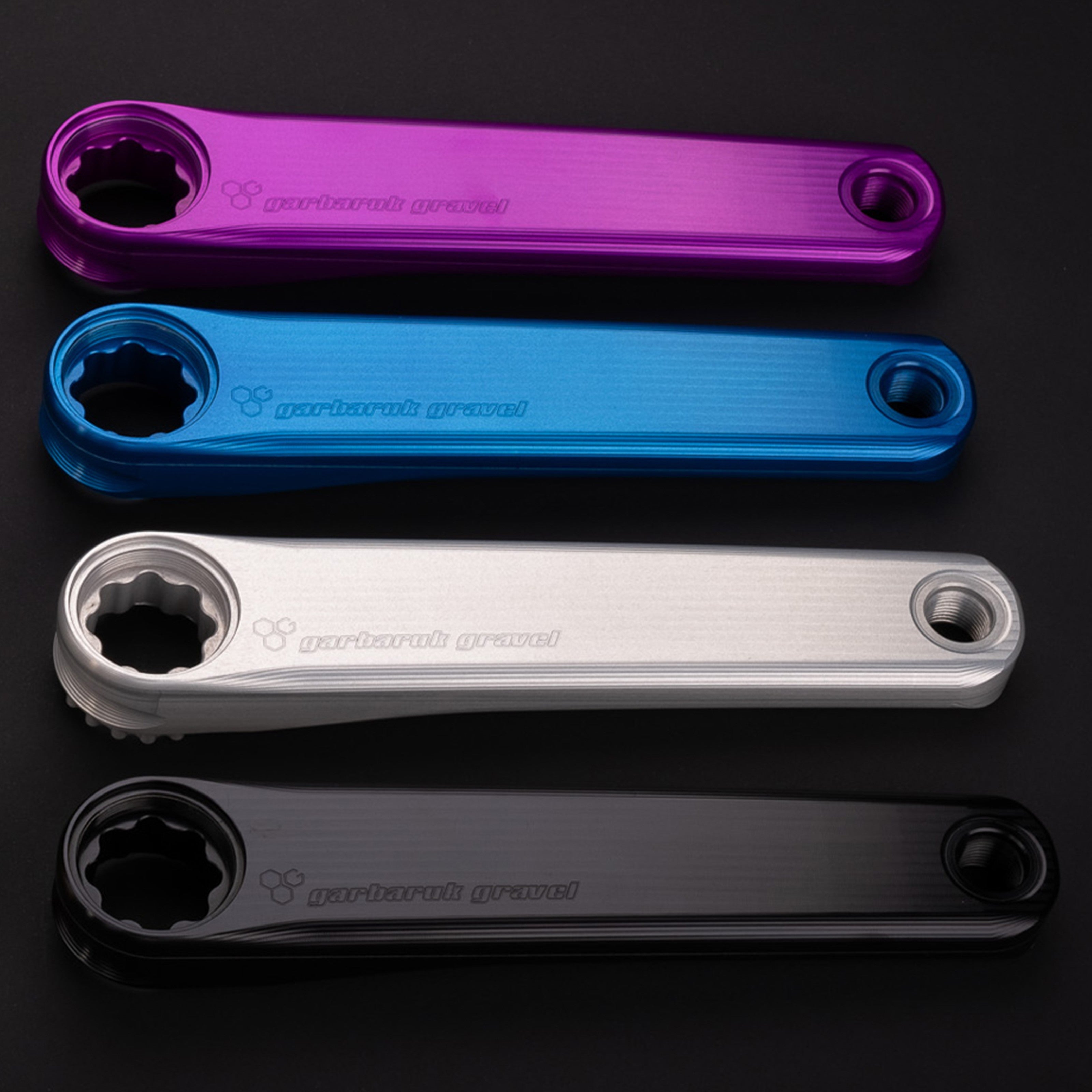 Garbaruk CNC-machined crank arms shown in different colours, highlighting anodised finish and lightweight, performance-driven design