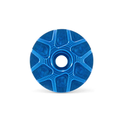 Garbaruk stem cap in blue, showcasing CNC-machined detailing and precision-engineered finish