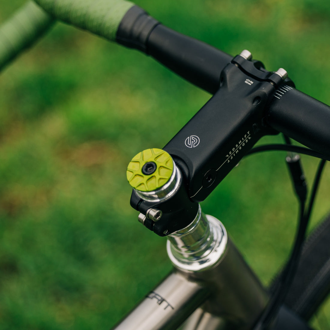 Garbaruk stem cap in green installed on a titanium Bossi bike, blending sleek aesthetics with functional performance