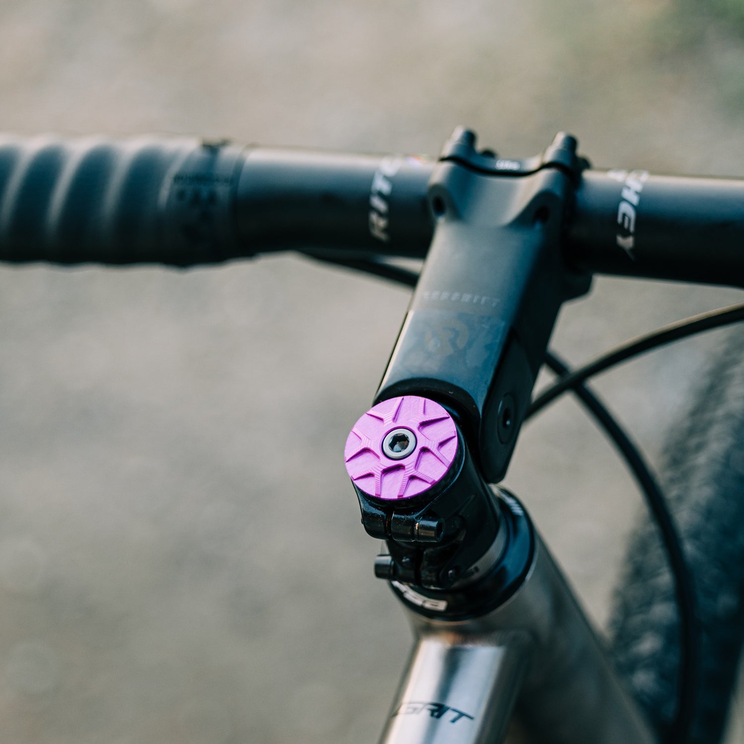 Garbaruk stem cap in violet installed on a titanium Bossi bike, showing seamless integration with premium componentse