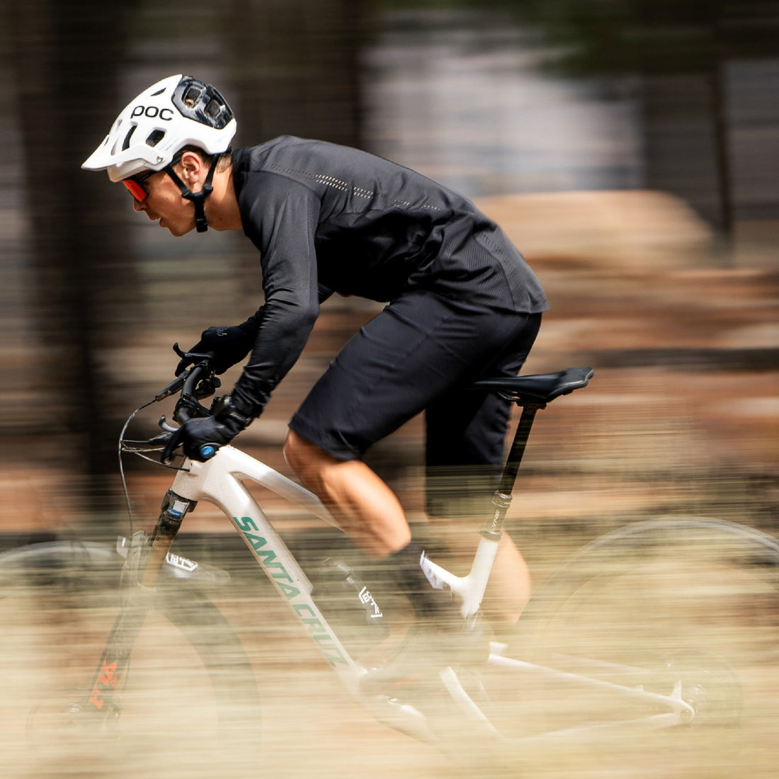 A mountain biker riding at speed, using a set of SQLab 710 2.0 ergonomic bike grips
