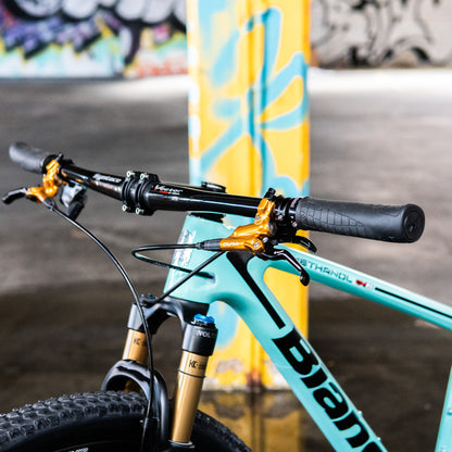 SQLab 711 grips installed on a flat bar mountain bike, photographed inside a colourful graffitied carpark