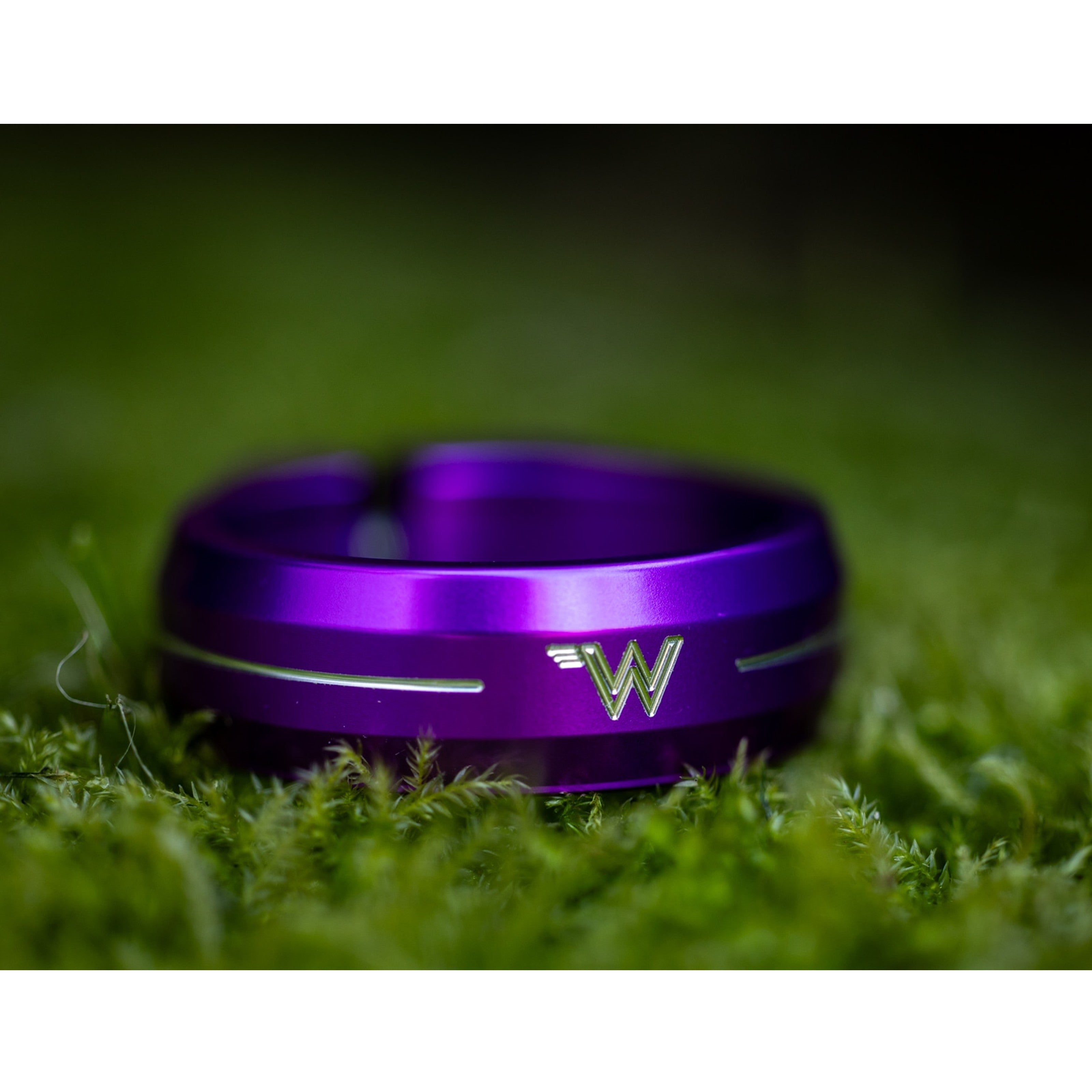 Purple White Industries Seat Collar, resting on a patch of greenery