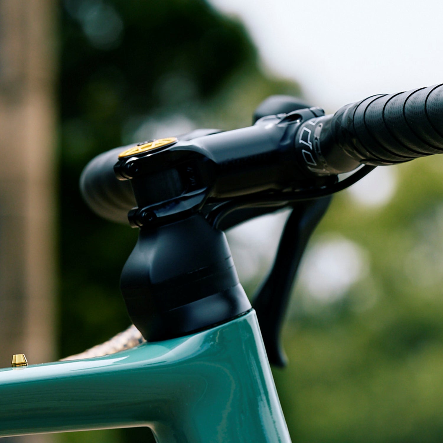 Side detail of an Extralite HyperStem ±6° installed on a carbon gravel bike with carbon handlebars
